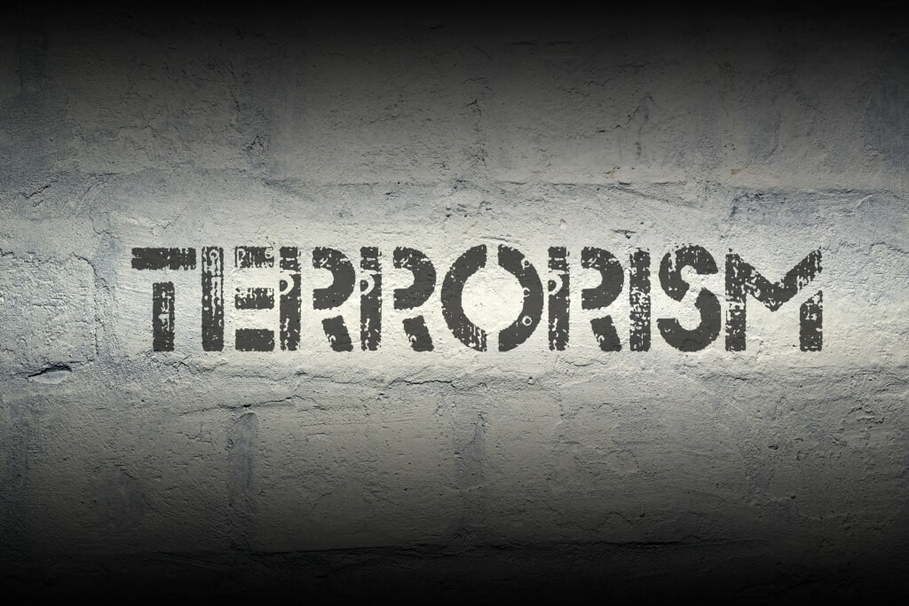 terrorism stencil print on the grunge white brick wall