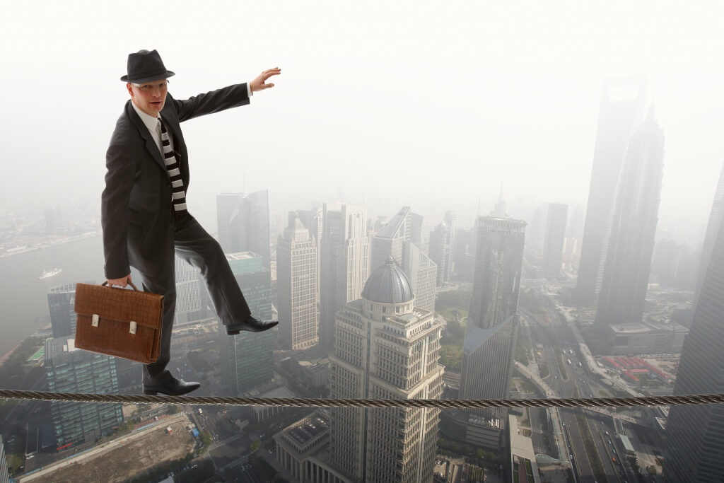 business man on tightwire signifying business risks