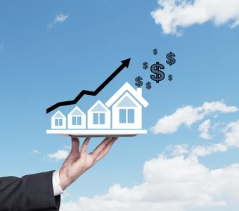 Hand Holding a House representing investments