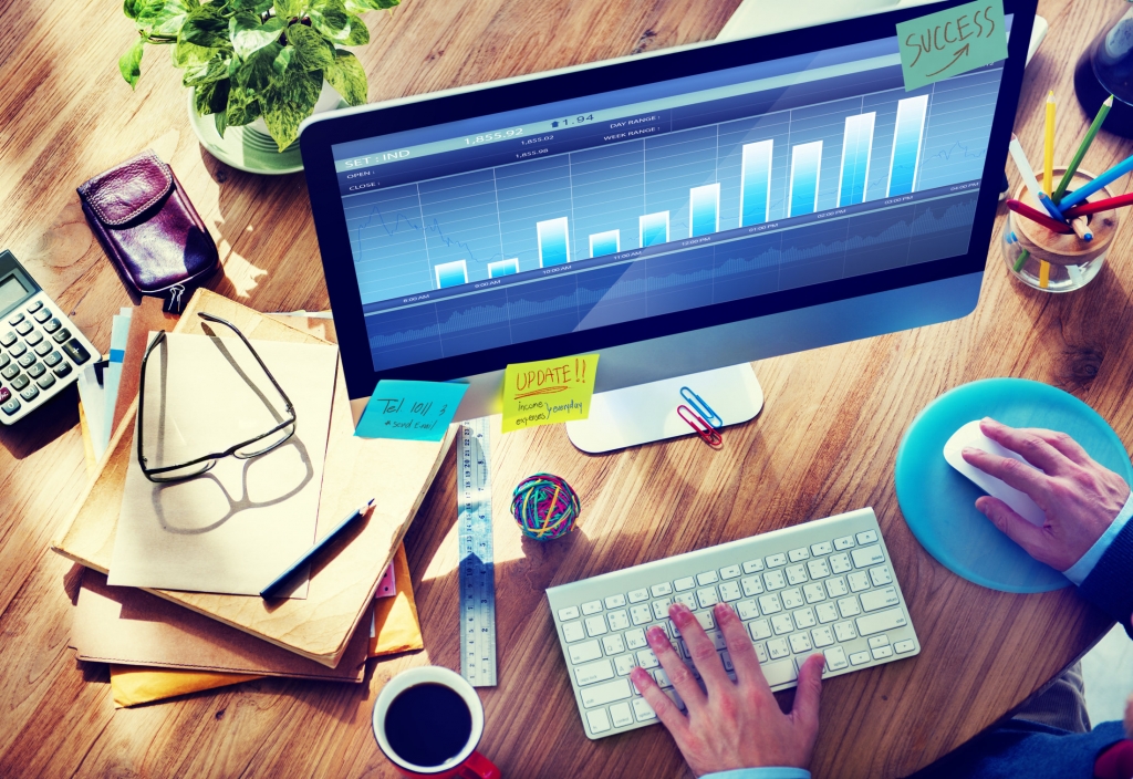 Man Analyzes the Market on Computer