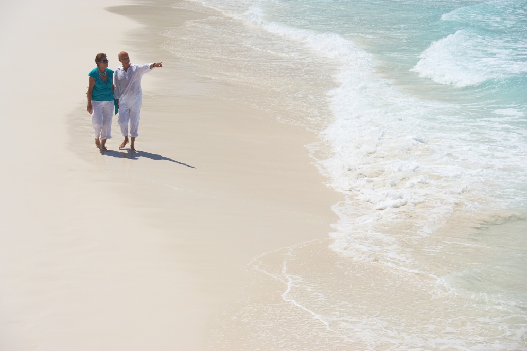 baby boomer couple on broad sandy beach